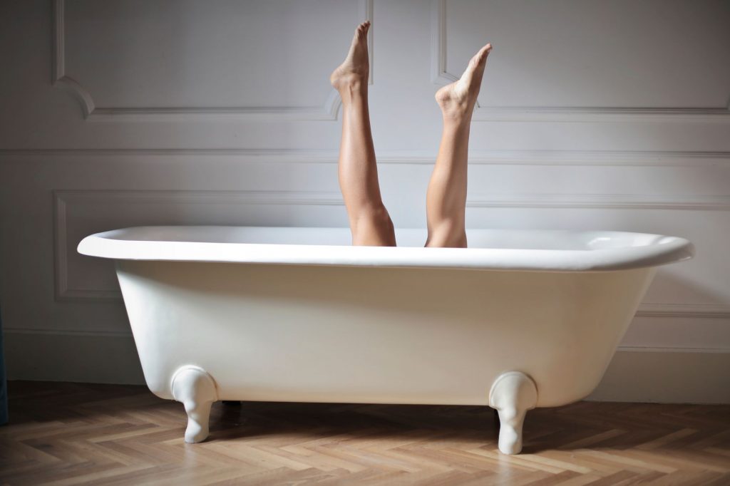 photo of female legs in bathtub